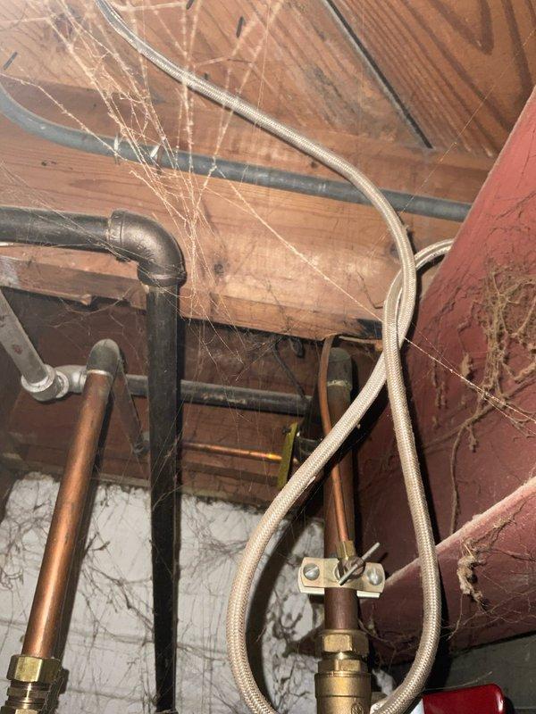 Responded to service call for hot water tank leak. Performed comprehensive inspection of plumbing system in utility area, focusing on copper supply lines, brass fittings, and flexible braided hoses. Identified and repaired leak source, ensuring proper connections and functionality of the hot water system.