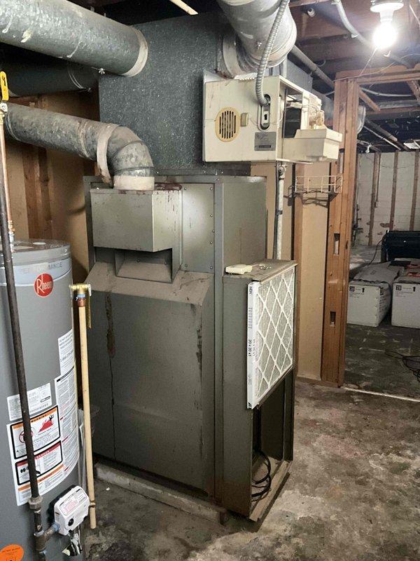 Performed full furnace replacement after identifying non-repairable belt failure. Removed existing aged unit and installed new Rheem furnace system in basement mechanical room. Connected new unit to existing ductwork and verified proper installation and operation.