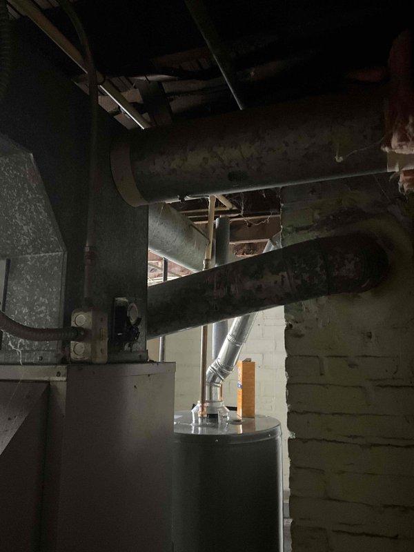 Performed full furnace replacement after identifying non-repairable belt failure. Removed existing aged unit and installed new Rheem furnace system in basement mechanical room. Connected new unit to existing ductwork and verified proper installation and operation.