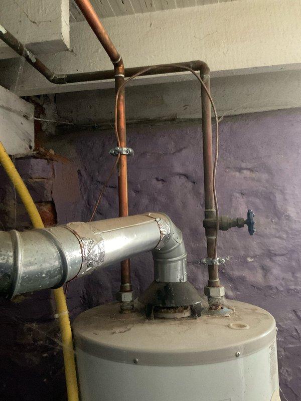 Conducted comprehensive assessment of leaking 40-gallon GE gas water heater. Unit displayed visible water leakage from bottom, requiring complete replacement. Provided detailed replacement quote for new gas water heater, including necessary plumbing modifications to existing copper and galvanized pipe connections.