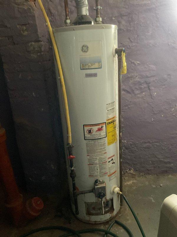 Conducted comprehensive assessment of leaking 40-gallon GE gas water heater. Unit displayed visible water leakage from bottom, requiring complete replacement. Provided detailed replacement quote for new gas water heater, including necessary plumbing modifications to existing copper and galvanized pipe connections.