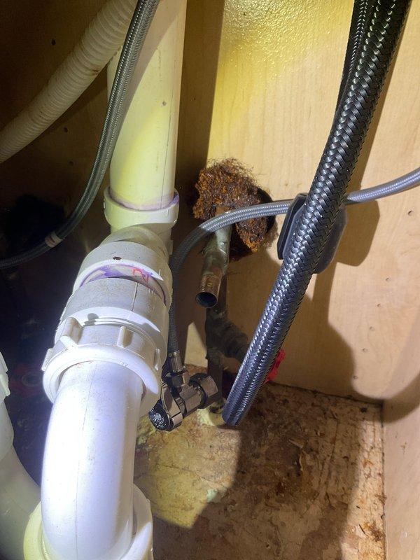 Responded to water leak service call at century-old residence. Discovered severe corrosion and water damage at main shutoff valve assembly, requiring access through ceiling to inspect copper supply lines. Replaced deteriorated valve components and installed new braided supply lines to resolve the persistent leak.