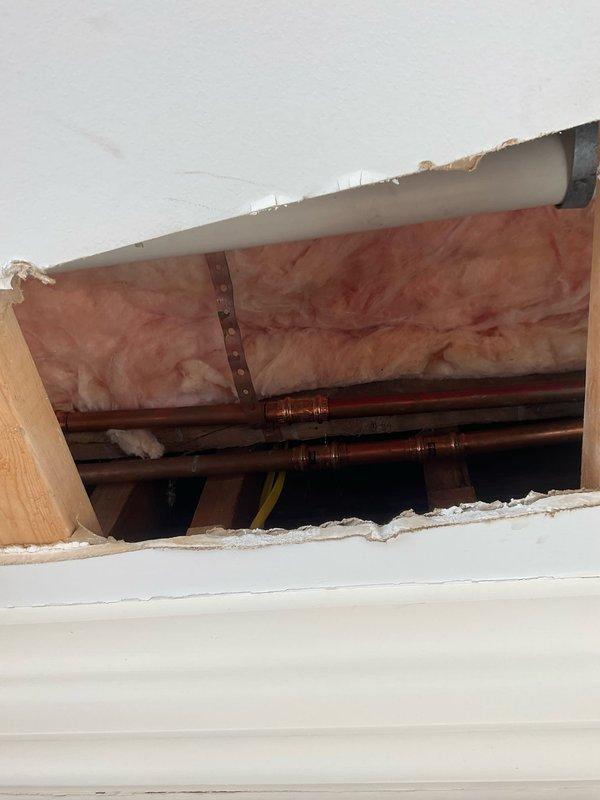 Responded to water leak service call at century-old residence. Discovered severe corrosion and water damage at main shutoff valve assembly, requiring access through ceiling to inspect copper supply lines. Replaced deteriorated valve components and installed new braided supply lines to resolve the persistent leak.