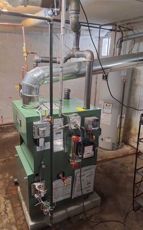 Completed installation of new steam gas boiler system including backflow preventer, automatic water feeder, and thermostat. Replaced deteriorated wet return piping and Hartford loop due to extensive leaks. Maintained existing 2.5" black pipe and customer opted to retain original steam main vents.