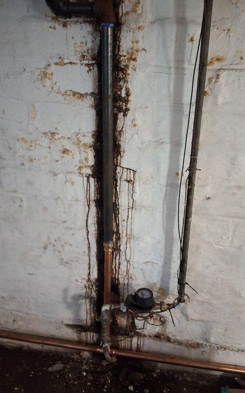 Completed installation of new steam gas boiler system including backflow preventer, automatic water feeder, and thermostat. Replaced deteriorated wet return piping and Hartford loop due to extensive leaks. Maintained existing 2.5" black pipe and customer opted to retain original steam main vents.