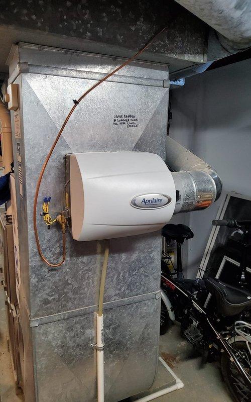 Performed annual maintenance on 5-year-old furnace system with Aprilaire humidifier attachment. Inspected PVC ventilation ducts, checked connections to metal ductwork, and verified proper operation of condensate drainage system. Installed new thermostat as requested by customer.