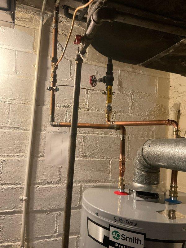 Responded to emergency service call for water heater failure. Discovered aging water heater with catastrophic leak from bottom of tank causing significant water damage to basement utility area. Provided quote for immediate replacement of the failed unit.