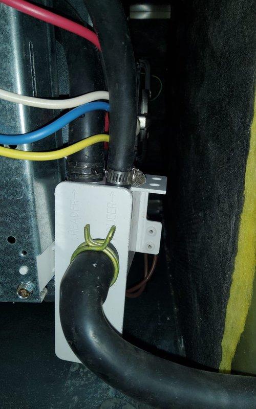 Investigated customer-reported leak following previous maintenance service. Inspected condensate drain system and identified improper connection at drain trap assembly. Properly secured condensate hose connections with appropriate clamps and verified system operation with no further leakage.