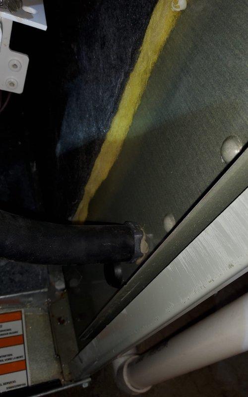 Investigated customer-reported leak following previous maintenance service. Inspected condensate drain system and identified improper connection at drain trap assembly. Properly secured condensate hose connections with appropriate clamps and verified system operation with no further leakage.