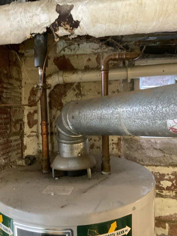 Successfully installed a new Bradford White tanked water heater in basement utility area, replacing the existing unit. Connected all necessary copper water lines, properly vented with metal ductwork, and installed expansion tank above the unit according to manufacturer specifications.