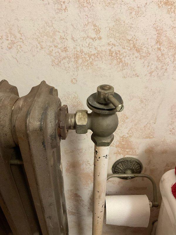 Responded to service call for clogged sink drain and slow leak in 55-year-old home. Inspected aging plumbing system, including connection to cast iron radiator with valve assembly in bathroom. Successfully cleared drain blockage and repaired leak at pipe fitting, restoring normal drainage and eliminating water seepage.