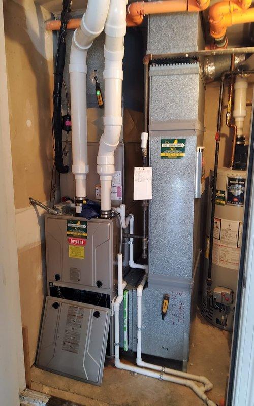 Performed scheduled cooling maintenance service on residential HVAC system between 12-4pm after providing call ahead notice. Inspected and serviced indoor air handler/furnace unit with associated PVC venting and electrical connections in mechanical room. Examined outdoor condensing unit mounted on concrete pad, noting proper installation of refrigerant lines and condensate drainage system, with all components functioning within specifications after service.