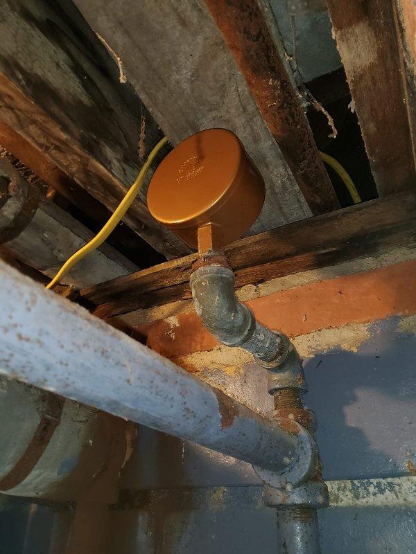 Replaced main ventilation component during warranty service. Installation included refitting black metal pipes with proper valve connections and securing junction points at wall openings. System now operating at optimal efficiency with all connections properly sealed.