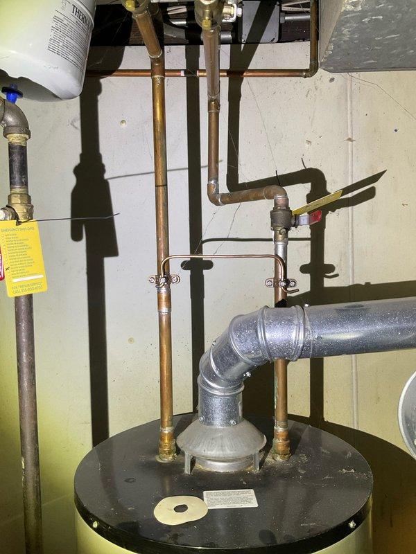 Responded to service call for a failing water heater in basement of century home. Performed maintenance on Unitrol-controlled tanked water heater including sediment flush from tank bottom as requested. Inspected copper supply lines, ventilation system, and control mechanism for proper function; confirmed heating element and temperature settings were operational after service.