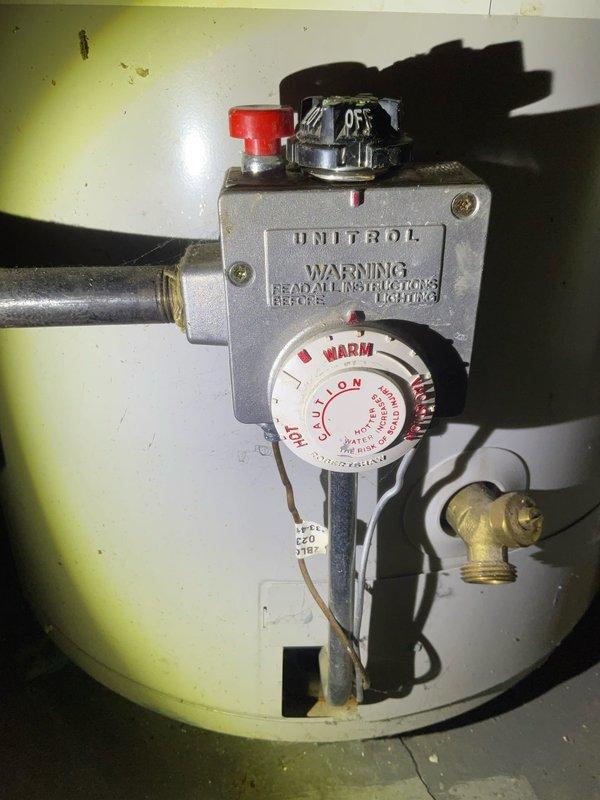 Responded to service call for a failing water heater in basement of century home. Performed maintenance on Unitrol-controlled tanked water heater including sediment flush from tank bottom as requested. Inspected copper supply lines, ventilation system, and control mechanism for proper function; confirmed heating element and temperature settings were operational after service.