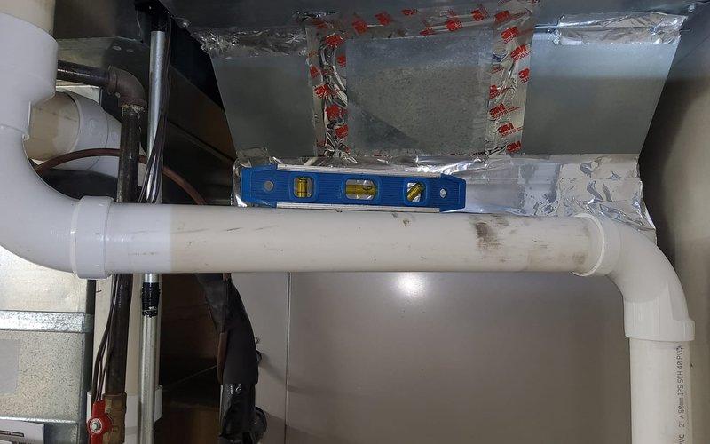 Responded to warranty service call regarding noise from recently installed furnace. Inspected system and leveled HVAC ductwork using spirit level. Checked and secured PVC condensate drainage system connected to the air handler unit (Filter #210), ensuring proper connection to condensate pump and verifying all seams on metal ductwork were correctly sealed with metallic tape.