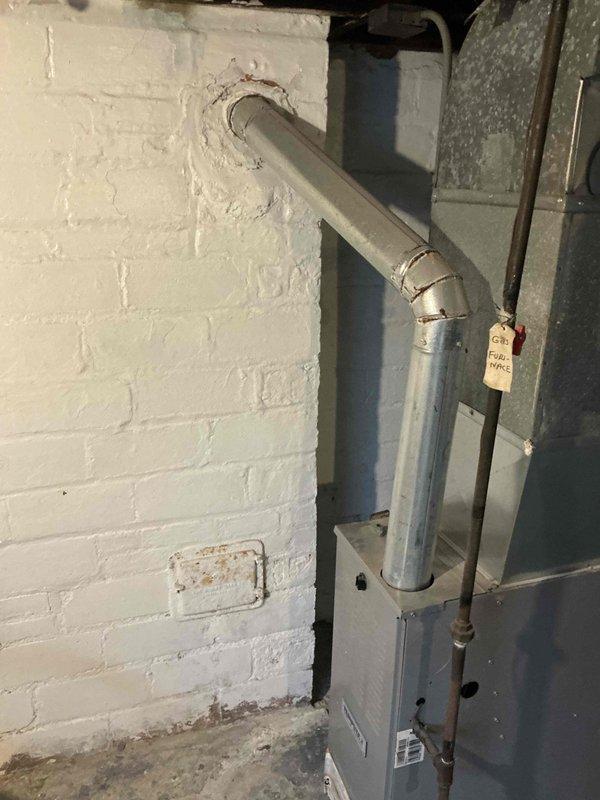 Successfully completed replacement of deteriorated flue pipes on Tempstar furnace, ensuring proper exhaust venting through exterior wall. New metal exhaust pipe with appropriate 90-degree bend was installed and sealed at wall penetration for safe and efficient operation.