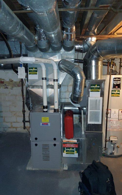 # HVAC Maintenance - Heating System Service Report

Completed scheduled preventive maintenance on a 2-year-old residential gas furnace system as part of the customer's maintenance plan. Performed comprehensive inspection of the heating unit, including visual assessment of the blower assembly, heat exchanger, ductwork connections, and overall system operation.

Accessed the blower compartment and inspected the squirrel cage fan assembly, noting dust accumulation on the blower wheel blades consistent with normal operation. Verified proper blower motor function and examined electrical connections for secure mounting and signs of wear. Inspected flexible metallic ductwork connections at the supply plenum, confirming proper installation and adequate support.

Evaluated the furnace cabinet and surrounding mechanical room components, including auxiliary HVAC equipment and associated copper piping. Checked insulated ductwork for proper sealing and support along ceiling-mounted runs. Verified a