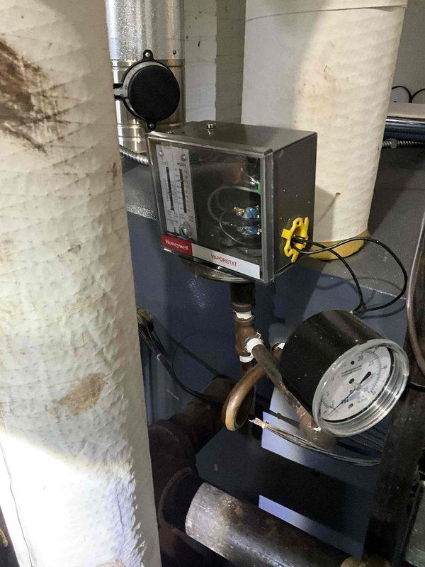 Performed estimate on steam boiler system with identified crack in heat exchanger. Documented existing boiler installation including piping configuration, insulation condition on steam lines, and overall system components for replacement assessment.