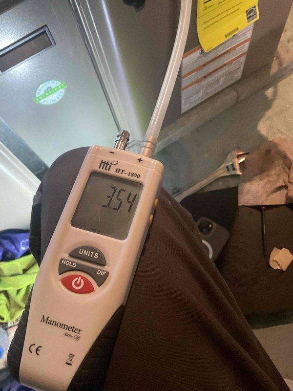 Completed comprehensive tune-up service on residential air conditioning and furnace system. Performed diagnostic testing using digital manometer to verify proper airflow and static pressure readings, measuring 75.4 inches water column within the air handler unit. Inspected internal components, electrical connections, and insulation integrity on both heating and cooling equipment to ensure optimal system performance and energy efficiency.
