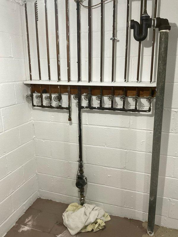 Responded to service call for leaking main water valve in basement. Upon arrival, inspected the main shut-off valves and plumbing manifold system. The chrome-handled wheel-style shut-off valves showed signs of active leaking at the connection points. Documented existing conditions including the PEX manifold distribution system, copper supply lines, and main valve assembly. Performed assessment of the leak source and surrounding plumbing infrastructure to determine necessary repairs.