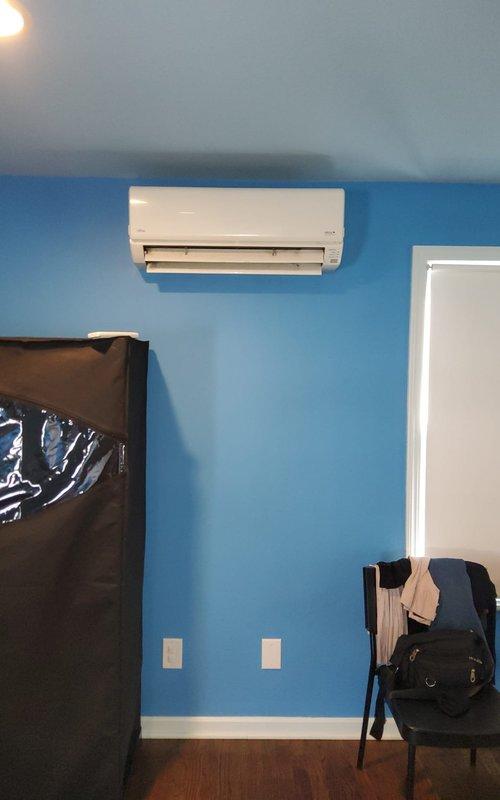 Responded to service call for non-operational mini split system over 10 years old. Performed diagnostic evaluation of both outdoor condensing unit and indoor wall-mounted air handler. Outdoor unit found partially obscured by overgrown landscaping, which may impact airflow and system efficiency. Completed system assessment and documented equipment condition with photographic evidence for service records.