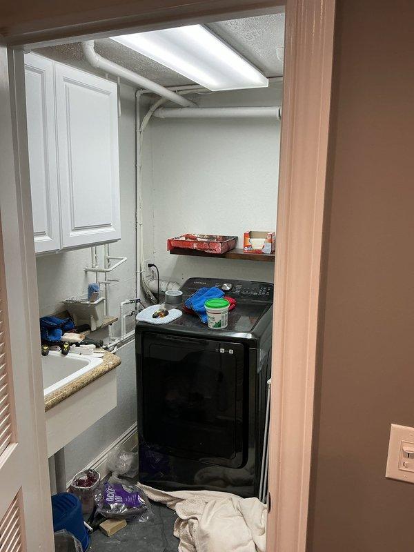 Conducted comprehensive on-site assessment for central air conditioning system replacement at residential property. Evaluated existing Rheem condensing unit located on exterior concrete pad and inspected indoor air handler installation in utility room with exposed ductwork. Documented current equipment configuration, electrical connections, and refrigerant line routing to provide detailed replacement estimate for complete AC system upgrade.