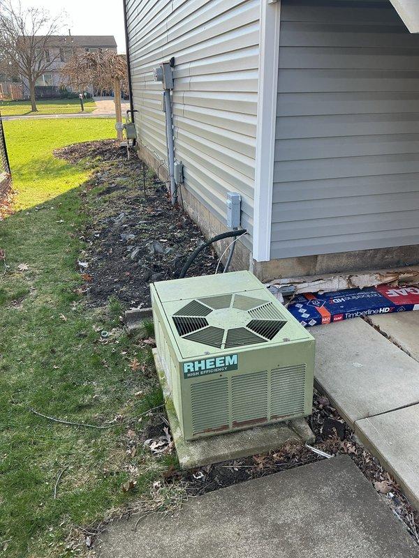 Conducted comprehensive on-site assessment for central air conditioning system replacement at residential property. Evaluated existing Rheem condensing unit located on exterior concrete pad and inspected indoor air handler installation in utility room with exposed ductwork. Documented current equipment configuration, electrical connections, and refrigerant line routing to provide detailed replacement estimate for complete AC system upgrade.