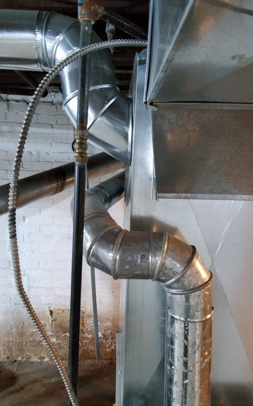 Responded to service call for inspection of newly installed furnace system that was completed by another contractor without proper permitting. Performed thorough visual inspection of furnace installation, ductwork connections, venting system, and associated piping to verify compliance with manufacturer specifications and safety standards. Documented installation conditions with photographs showing gray HVAC furnace unit with metallic ductwork, blue water heating equipment, copper and black piping connections, and flexible metal conduit. Assessed workmanship quality, proper equipment clearances, condensate drainage setup with collection pan, and overall system configuration in basement mechanical room. Coordinated with management regarding permit concerns and determined appropriate next steps for customer given circumstances of unpermitted installation by third-party contractor.