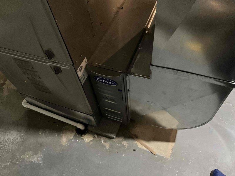 Completed HVAC replacement estimate for a 24-year-old Carrier air conditioning system, including evaluation of both the indoor air handler unit located in the basement mechanical room and the outdoor Allegiance 10 condenser unit (Model 7A0048B100A1, SEER 10.0, manufactured 05/2002). Documented existing equipment conditions with photographs and confirmed customer contact information for proposal delivery.