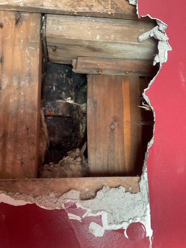 Completed comprehensive plumbing stack assessment and repair work involving sump pump system and exterior spigot connections over a four-day period with two-person crew. Performed exploratory demolition of interior wall and ceiling sections to access concealed plumbing infrastructure, exposing vertical stack assembly, supply lines, and drainage components. Documented extensive water damage and deterioration to wall framing and drywall materials, indicating previous moisture intrusion requiring remediation prior to system repairs and wall restoration.