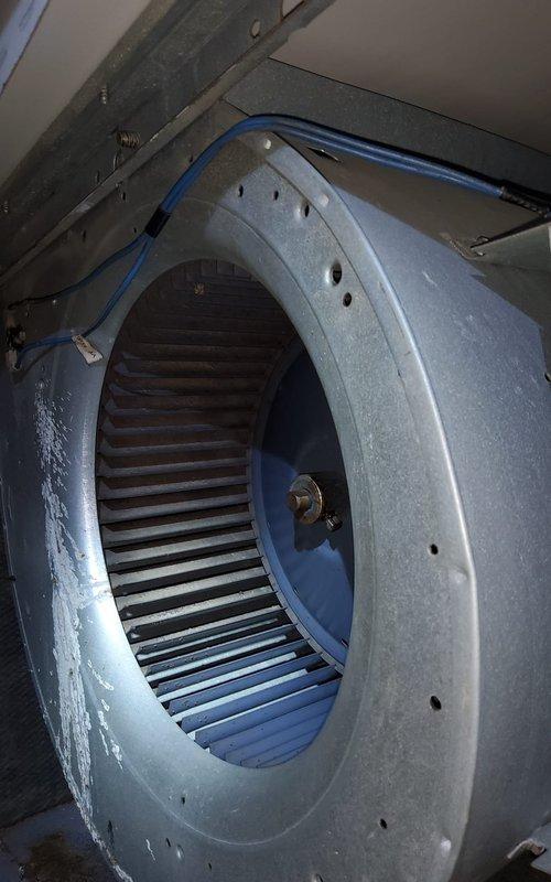 Responded to service call for furnace producing unusual noises with suspected blower motor issue. Upon inspection, accessed furnace cabinet and performed thorough diagnostic evaluation of blower assembly and internal components. Examined blower motor, wheel, and housing for signs of wear, debris accumulation, or mechanical failure. Inspected electrical connections, including motor capacitor leads and wiring harnesses for proper termination and continuity. Evaluated condition of heat exchanger, burner assembly, and gas valve controls. Documented system condition through photographic evidence showing blower wheel configuration, motor mounting, and overall furnace component layout. Noted visible corrosion on burner tubes and general aging of unit, indicating extended service life. Provided customer with findings and recommendations for addressing noise concern and discussed potential repair or replacement options based on equipment age and condition.