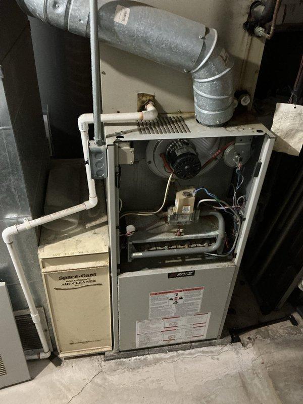 Responded to service call for furnace producing unusual noises with suspected blower motor failure. Upon inspection, found aging furnace system with accessible blower compartment and determined unit required replacement due to age and condition. Provided comprehensive estimate for complete HVAC system replacement including new furnace installation, ductwork connections, and associated components to restore reliable heating operation.