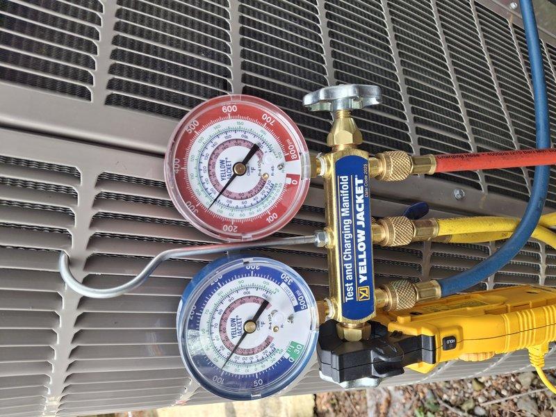 Performed comprehensive tune-up service on two Bryant AC units, each approximately two years old and in good working condition. Conducted full system diagnostics using manifold gauge set to verify refrigerant pressures and charge levels on R-22 system, inspected condenser coils and fan assemblies, and confirmed both outdoor units were operating within manufacturer specifications. All components tested satisfactorily with no repairs required, leaving both systems prepared for summer cooling season.
