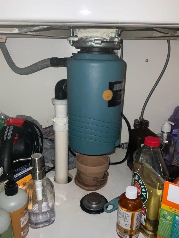 Responded to service call for garbage disposal leak beneath kitchen sink. Upon inspection, identified small leak at disposal mounting flange connection to sink basin. Tightened mounting bolts and inspected drain connections, including corrugated drain hose and PVC discharge pipe assembly. Verified proper sealing of all connections, tested disposal operation, and confirmed leak was resolved with no further water discharge observed.