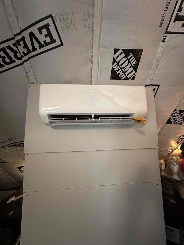 Installed ductless mini-split system with console-style indoor unit mounted on third floor landing and outdoor condenser positioned at rear of building alongside existing AC equipment. Due to roofline constraints limiting installation options, routed refrigerant lines and electrical connections through basement to reach rear condenser location. Installed insulated line set with proper pitch for condensate drainage, made refrigerant connections with brass service fittings, evacuated system, and charged to manufacturer specifications. Verified system operation with digital manifold gauges, confirmed temperature differential across coil, and programmed thermostat controls. Integrated electrical connections into existing panel which had adequate capacity for new equipment.