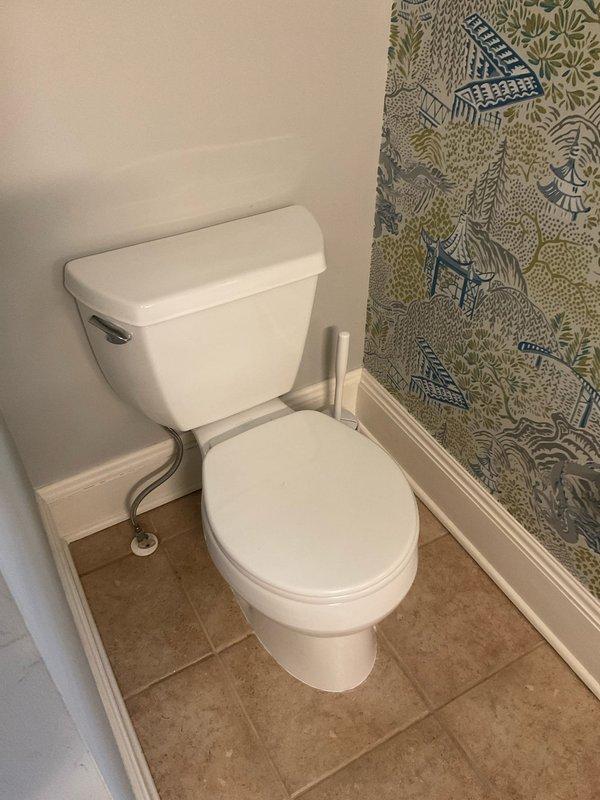 Responded to call for leaking pipe affecting wall in residential bathroom. Upon arrival, conducted thorough visual inspection of bathroom area including toilet, walls, flooring, and adjacent fixtures. Examined wall surfaces for moisture intrusion, discoloration, or visible damage indicators. Inspected toilet installation, supply line connections, wax ring seal, and tank components for potential leak sources. Checked floor tile grout lines and baseboard areas for water penetration or staining. Assessed plumbing fixtures and connections within accessible areas of bathroom. Documented conditions with photographs for service records. No active leak observed during inspection period. Advised monitoring for recurrence and provided recommendations for follow-up if symptoms return.