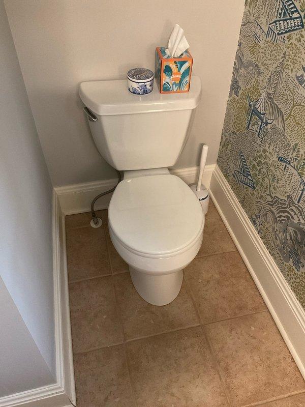 Responded to call for leaking pipe affecting wall in residential bathroom. Upon arrival, conducted thorough visual inspection of bathroom area including toilet, walls, flooring, and adjacent fixtures. Examined wall surfaces for moisture intrusion, discoloration, or visible damage indicators. Inspected toilet installation, supply line connections, wax ring seal, and tank components for potential leak sources. Checked floor tile grout lines and baseboard areas for water penetration or staining. Assessed plumbing fixtures and connections within accessible areas of bathroom. Documented conditions with photographs for service records. No active leak observed during inspection period. Advised monitoring for recurrence and provided recommendations for follow-up if symptoms return.
