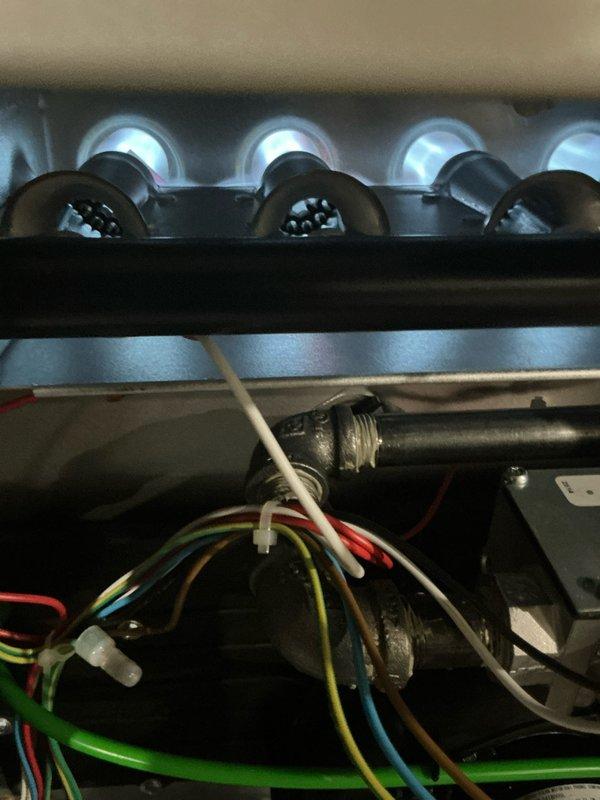 Responded to service call for thermostat error code on furnace installed last August. Performed comprehensive furnace tune-up including inspection of burner assembly, blower wheel, and all operational components. Verified proper combustion with blue flame pattern across burner assembly, inspected blower wheel for dust accumulation and wear, and checked all electrical connections and wiring harnesses. Completed humidifier tune-up as part of preventative maintenance service. Reset service reminder and documented system operation with photographic records showing burner operation and internal components functioning properly.