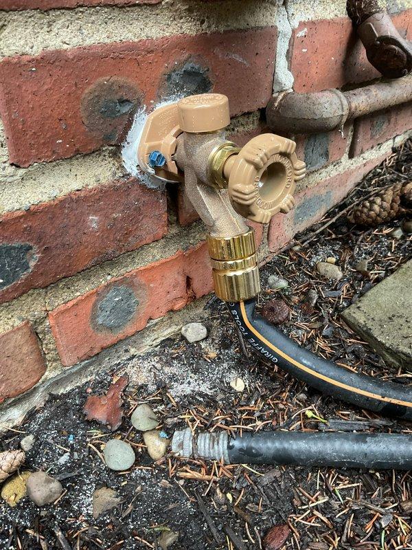 Responded to burst pipe emergency at century-old residential property. Accessed plumbing infrastructure through interior wall opening, where copper and PVC pipe connections were inspected and repaired. Exterior hose bib and associated piping mounted to brick foundation were also serviced to address water line failure and restore proper function to the plumbing system.