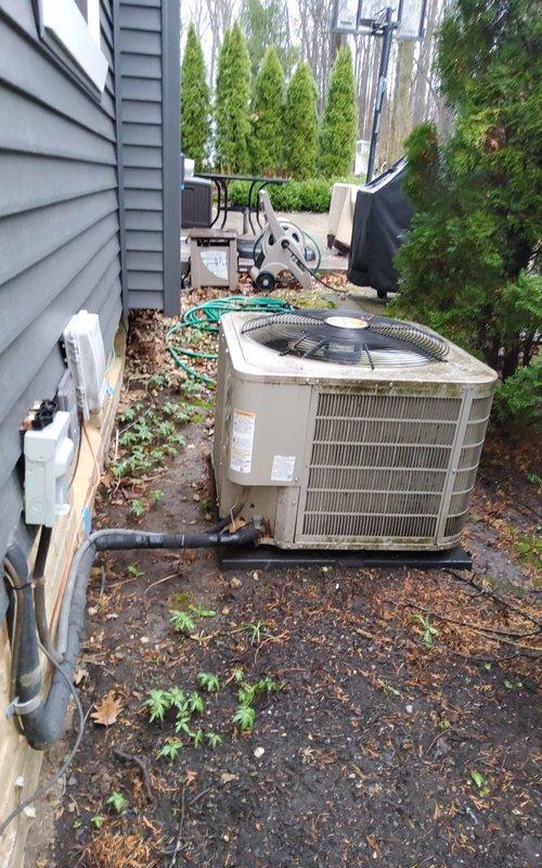 Completed comprehensive cooling season maintenance on residential air conditioning system. Performed standard tune-up procedures including inspection of outdoor condensing unit, verification of electrical connections at disconnect box, and assessment of unit operation in preparation for cooling season. System found in satisfactory condition with unit properly positioned on pad and all components accessible for service.