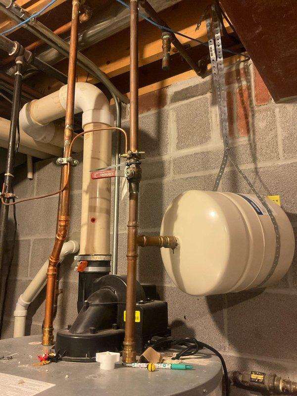 Performed routine maintenance on Bradford White automatic storage water heater, completing a comprehensive flush and fill procedure to remove sediment buildup and ensure optimal performance. Documented equipment condition with photographs showing proper connections, copper piping configuration, and circulation pump operation. All system components, including expansion tank and associated plumbing connections, were inspected and found to be functioning within normal parameters.