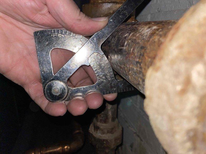 Returned to complete boiler pipe repair following asbestos abatement. Replaced corroded and leaking section of boiler piping that was previously identified during initial service visit. Installed new pipe section with threaded fittings, tested system for leaks, and verified proper operation of boiler and associated plumbing connections.