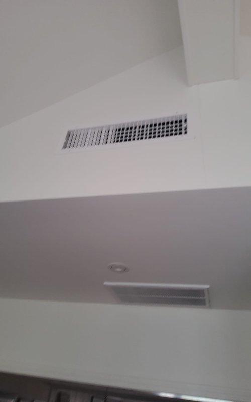 Completed preventive maintenance on two split HVAC systems serving a multi-level residence. Serviced main floor unit including cleaning of heavily soiled outdoor condenser coil with significant dirt and debris accumulation, inspected indoor air handler and ceiling-mounted supply register for proper airflow. Performed similar maintenance procedures on basement system to ensure optimal cooling performance for both zones.