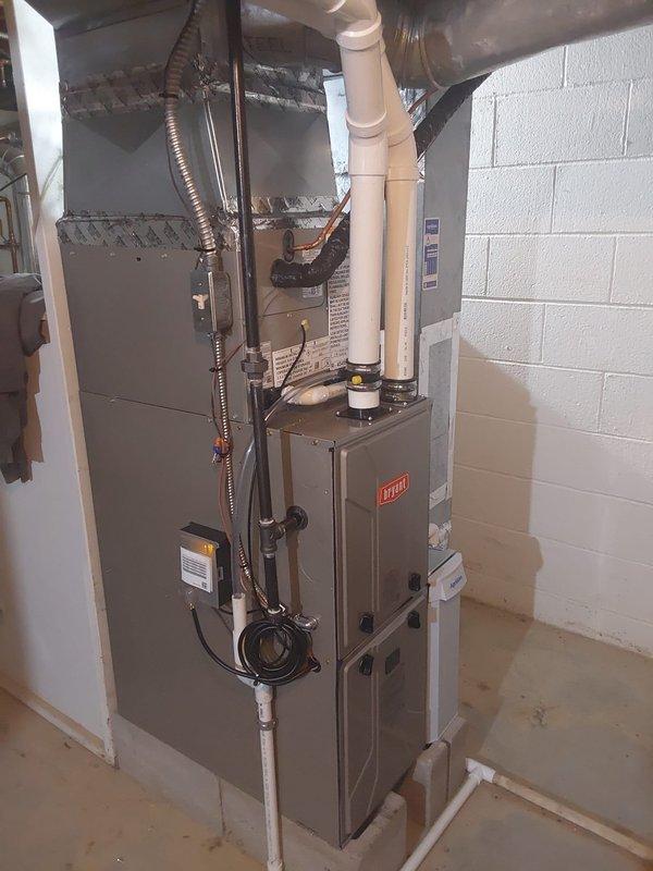 Completed full HVAC system replacement for a 2-story addition, converting from cooling-only to complete heating and cooling. Installed new Bryant furnace with evaporator coil, outdoor condenser unit, and programmable thermostat. Vented furnace exhaust through crawlspace using PVC piping. Reused existing airflow base and integrated air cleaner beneath furnace for improved indoor air quality.

Replaced refrigerant linesets that previously ran under a removed deck, securing new lines to exterior siding and enclosing in line hide for protection and aesthetics. Routed lineset under slider door to maintain proper clearance and appearance. Connected to existing gas supply located near main house boiler system. Installed electrical disconnect and completed all wiring connections to code.

System tested and operational, providing both heating and cooling capabilities to the addition with proper airflow distribution through existing ductwork.