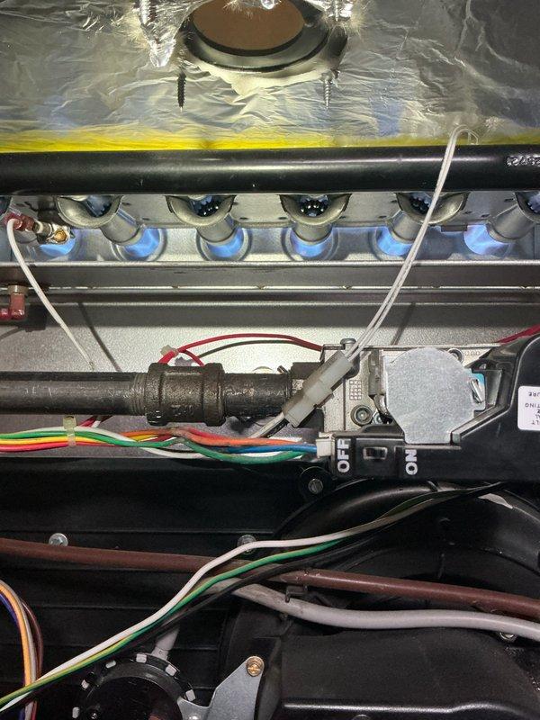 Responded to service call for furnace displaying error code indicating filter maintenance required. Upon arrival, performed system inspection and documented equipment condition. Found significant rust discoloration on internal metal surfaces visible through ventilation slots of drain pan area, indicating potential corrosion concerns. Inspected gas burner assembly, ignition components, gas valve, and control wiring - all appeared operational. Advised homeowner of filter replacement requirement per error code and discussed rust findings observed in base pan area for future monitoring.