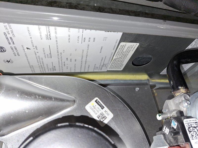 Completed comprehensive air conditioning maintenance tune-up on residential cooling system. Performed thorough inspection of indoor air handler unit, including blower assembly, motor housing, and refrigerant line connections. Documented equipment specifications and current system condition with photographs. Noted moderate dust and debris accumulation on exterior condenser unit and surrounding area, with visible leaf debris and surface corrosion on refrigerant line connections. All mechanical components operating within normal parameters at time of service. System confirmed to be functioning properly upon completion of preventive maintenance procedures.