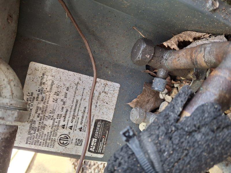 Completed comprehensive air conditioning maintenance tune-up on residential cooling system. Performed thorough inspection of indoor air handler unit, including blower assembly, motor housing, and refrigerant line connections. Documented equipment specifications and current system condition with photographs. Noted moderate dust and debris accumulation on exterior condenser unit and surrounding area, with visible leaf debris and surface corrosion on refrigerant line connections. All mechanical components operating within normal parameters at time of service. System confirmed to be functioning properly upon completion of preventive maintenance procedures.