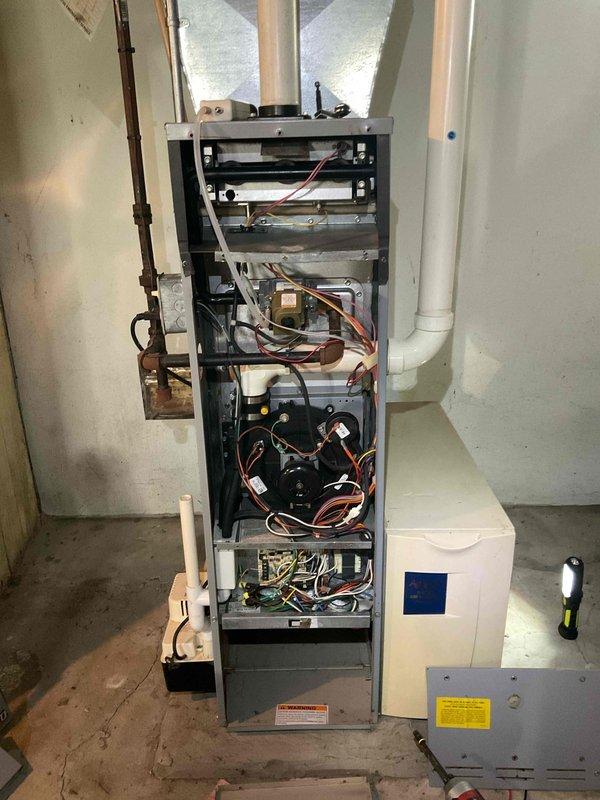 Completed comprehensive heating system tune-up on residential furnace unit. Performed full system inspection with front access panel removed, examining all internal components including blower motors, circuit boards, wiring harnesses, and ductwork connections. Measured supply air temperature at evaporator coil registering 61.8°F, noted moderate dust accumulation on coil fins. System operating properly at time of service with all components functioning within normal parameters. Accessory humidifier unit inspected and confirmed operational.