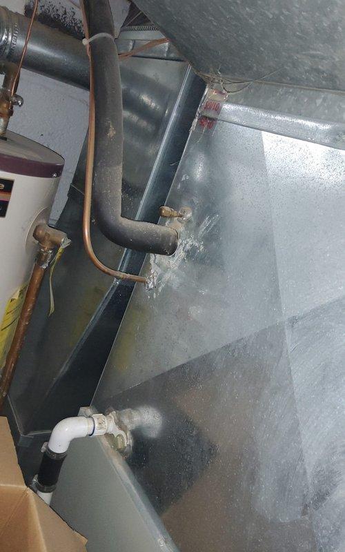 Responded to service call for air conditioning system requiring refrigerant recharge. Upon arrival, performed visual inspection of outdoor condensing unit and indoor air handler components. Assessed refrigerant levels and system pressures at service ports located near indoor evaporator coil. Confirmed low refrigerant charge through pressure readings and system performance evaluation. Added refrigerant to manufacturer specifications, monitoring gauges throughout charging process to achieve proper subcooling and superheat values. Verified brass service valves and copper refrigerant lines showed no visible signs of leakage. Checked condensate drain line and PVC drainage system for proper operation. Cycled system through complete cooling operation to confirm adequate cooling performance and proper system function. Unit returned to normal operating parameters with appropriate temperature differential across evaporator coil.